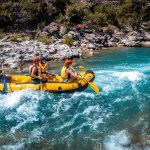 a group of people riding on the back of a raft